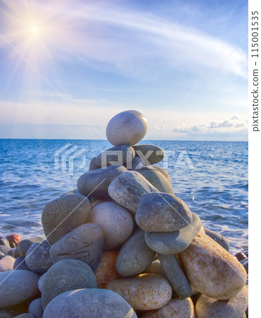 cone is formed of pebbles on seashore 115001535