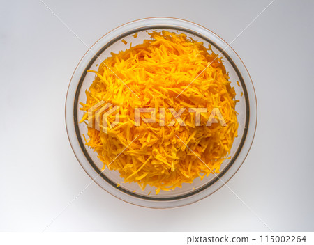 Grated fresh raw pumpkin prepared for cooking. Healthy vegetarian food ingredient. Grated fresh raw pumpkin prepared for cooking. Healthy vegetarian food ingredient. 115002264