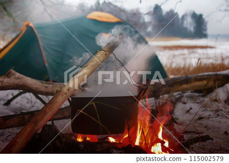 picnic in winter on nature of a bonfire picnic in winter on nature of a bonfire 115002579