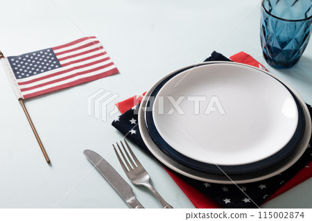 Patriotic table setting with USA flag and decoration in national flag colors on white blue background. Independence Day. Happy Memorial Day. Close up. Patriotic table setting with USA flag and decoration in national flag colors on white blue background. Independence Day. Happy Memorial Day. Close up. 115002874