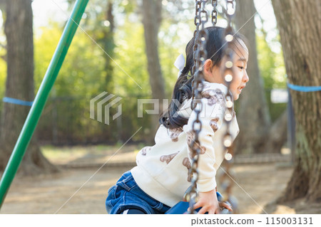 Children enjoying athletics in the park 115003131