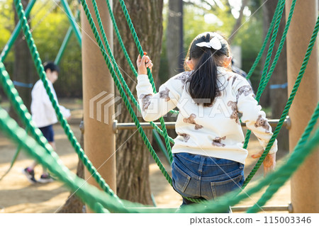 Children enjoying athletics in the park 115003346