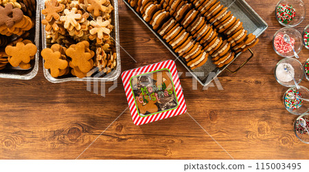 Lovingly homemade gingerbread and sugar cookies, half-dipped in rich chocolate, nestled in decorative Christmas tin boxes perfect for seasonal gifting. Lovingly homemade gingerbread and sugar cookies, half-dipped in rich chocolate, nestled in decorative Christmas tin boxes perfect for seasonal gifting. 115003495