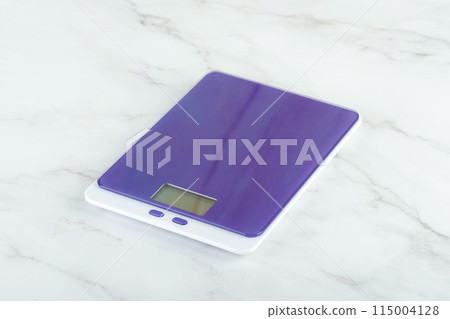 New purple kitchen scale on the kitchen table. 115004128