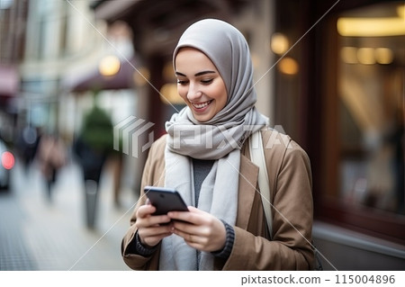Muslim woman using phone 115004896