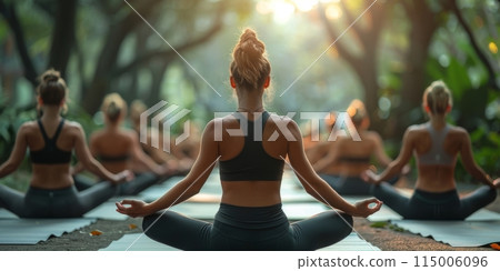 Group of adults attending a yoga class outside in park with natural background Group of adults attending a yoga class outside in park with natural background 115006096