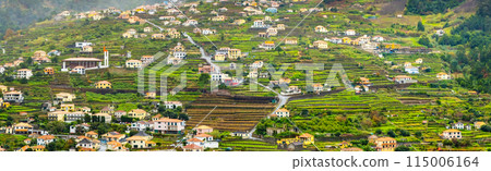 Traditional terrace village Sao Vicente, Madeira Island, Portugal. Small houses and gardens among a green mountain landscape in stormy weather. 115006164