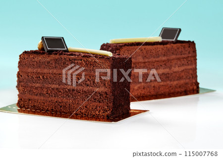 Slices of chocolate cake topped with crunchy streusel on blue background Slices of chocolate cake topped with crunchy streusel on blue background 115007768