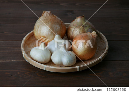 Raw garlic and onion on a wooden table Raw garlic and onion on a wooden table 115008268