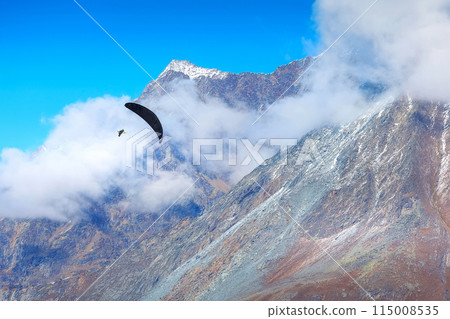 Paraglider over Swiss Alps, Switzerland 115008535