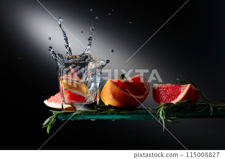 Cocktail with grapefruit slices and rosemary. 115008827