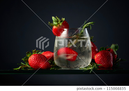 Cocktail gin tonic with ice, strawberries, and rosemary. Cocktail gin tonic with ice, strawberries, and rosemary. 115008835