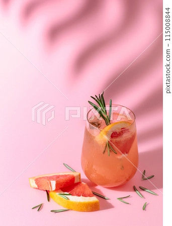 Summer cocktail with grapefruit, rosemary, and ice. 115008844