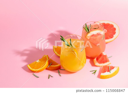 Summer cocktails with grapefruit, orange, rosemary, and ice. Summer cocktails with grapefruit, orange, rosemary, and ice. 115008847