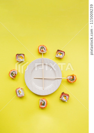 Sushi delivery. Set of rolls in a disposable box on a black background. Top view Sushi delivery. Set of rolls in a disposable box on a black background. Top view 115009239