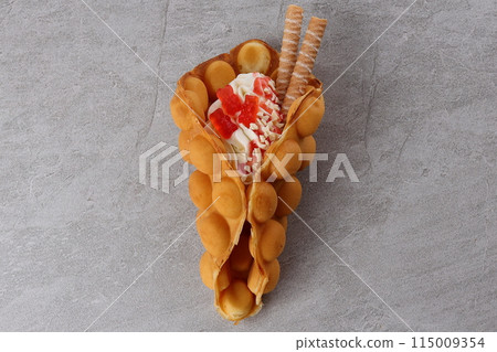 Delicious sweet bubble waffle on table Delicious sweet bubble waffle on table 115009354