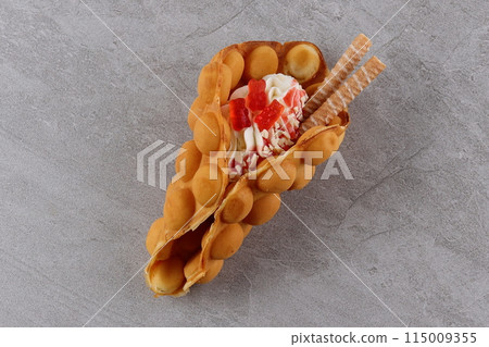 Delicious sweet bubble waffle on table Delicious sweet bubble waffle on table 115009355