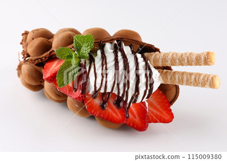 Hong kong or bubble waffle with ice cream, chocolate, marshmallows and strawberries isolated on white background Hong kong or bubble waffle with ice cream, chocolate, marshmallows and strawberries isolated on white background 115009380