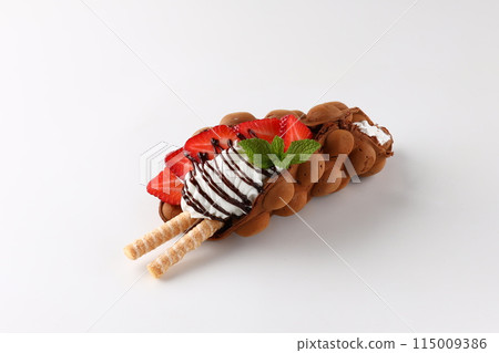 Hong kong or bubble waffle with ice cream, chocolate, marshmallows and strawberries isolated on white background 115009386