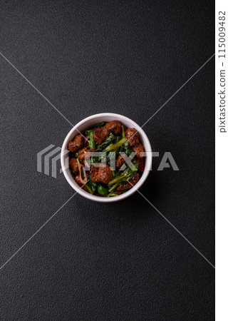 Delicious warm salad with pieces of meat, spinach, tomatoes, salt, spices and herbs Delicious warm salad with pieces of meat, spinach, tomatoes, salt, spices and herbs 115009482