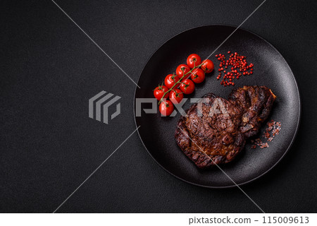 Delicious juicy beef ribeye steak grilled with salt, spices and herbs Delicious juicy beef ribeye steak grilled with salt, spices and herbs 115009613