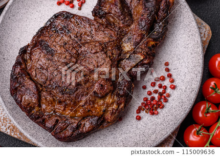 Delicious juicy beef ribeye steak grilled with salt, spices and herbs Delicious juicy beef ribeye steak grilled with salt, spices and herbs 115009636