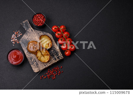 Delicious halved potatoes grilled with salt, spices and herbs 115009678