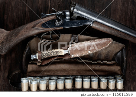 double barreled side shotgun with cartridges in bandolier. double barreled side shotgun with cartridges in bandolier. 115011599