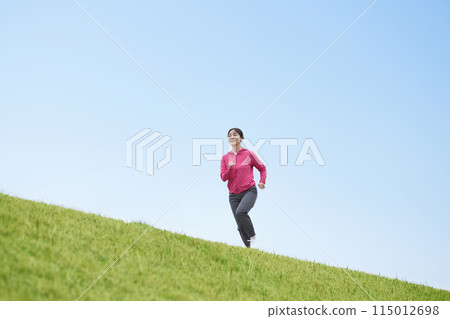 Middle-aged woman running in sportswear Middle-aged woman running in sportswear 115012698