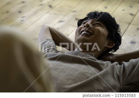 Man lying on floor 115013583