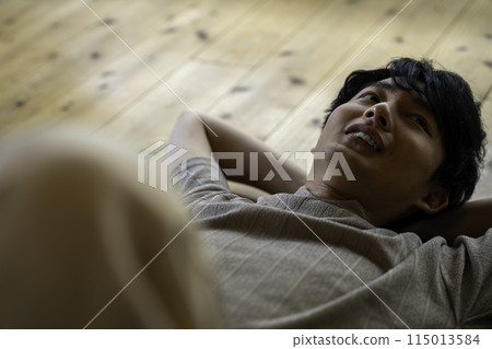 Man lying on floor Man lying on floor 115013584