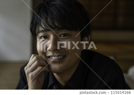 Man lying down at home 115014166