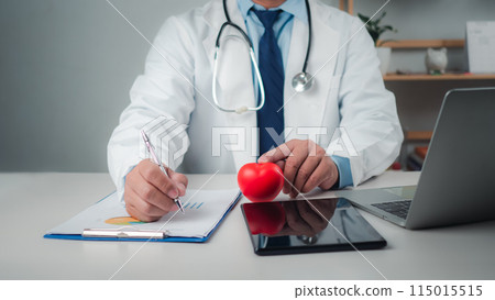 Doctor showing a red heart at hospital office, Healthcare worker and doctor service, Digital laptop in modern office, Medical technology concept, Health insurance concept, Health planning concept. Doctor showing a red heart at hospital office, Healthcare worker and doctor service, Digital laptop in modern office, Medical technology concept, Health insurance concept, Health planning concept. 115015515