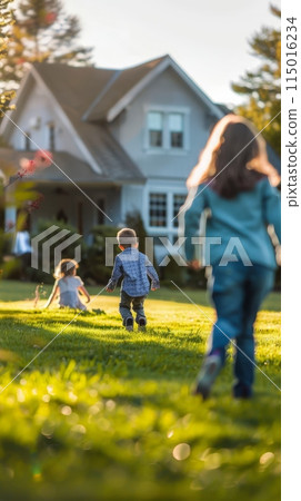 Children running on a lush green lawn towards a house. Symbol of family, play, and home life. 115016234