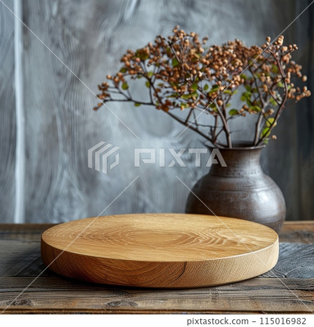 Flowers in vase behind a wooden serving board 115016982