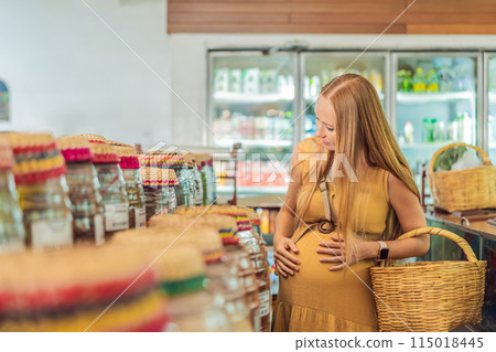 A pregnant woman is at a fruit stand in a grocery store Pregnant woman buying organic vegetables and fruits at Mexican style farmers market 115018445