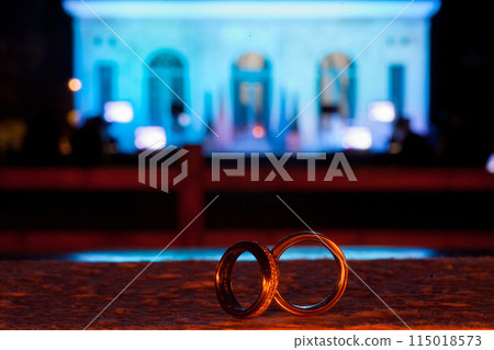 Romantic scene with wedding rings against a cityscape backdrop, symbolizing love and commitment 115018573