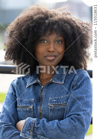 Confident Woman in Denim Jacket Poses Outdoors Urban Fashion Street Style Portrait Confident Woman in Denim Jacket Poses Outdoors Urban Fashion Street Style Portrait 115018631