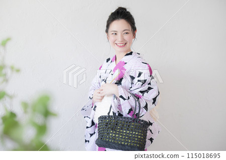 A woman wearing a yukata with a bag 115018695