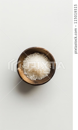 Wooden bowl filled with coarse sugar substitute granules on a white background. Ideal for low-calorie and sugar-free diets. 115019315