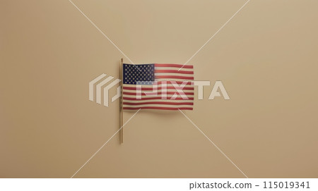 Small American flag on a beige wall. Simple and elegant patriotic display. 115019341