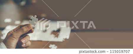 Banner Implement puzzle improve hand holding together solve synergy organize team connection plan trust strategy. Stakeholder business trust teams hands holding jigsaw puzzle synergy with copy space 115019707