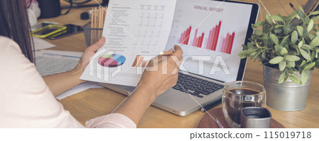 Banner woman working office desk reading financial report finance chart graph on table. Wide tax audit woman hands working paperwork office. Banner Businesswoman Audit financial with copy space 115019718