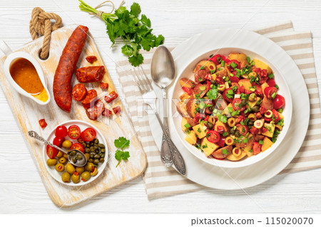 spanish potato salad with chorizo in white bowl spanish potato salad with chorizo in white bowl 115020070