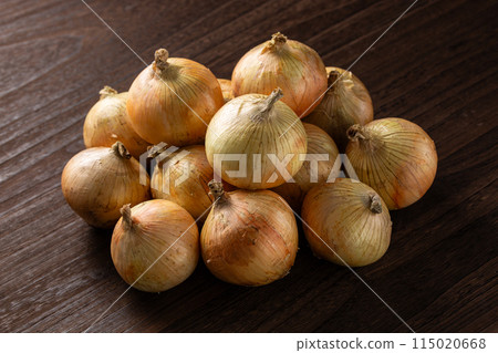 A lot of onions on a wooden table A lot of onions on a wooden table 115020668