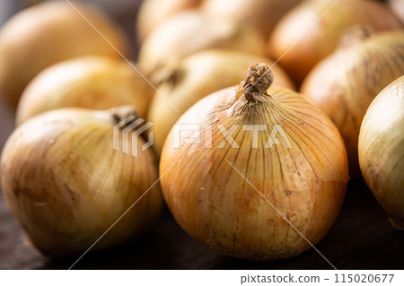 A lot of onions on a wooden table A lot of onions on a wooden table 115020677