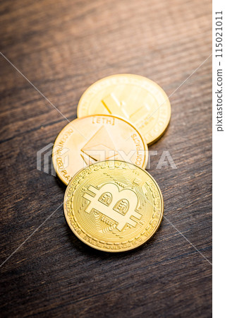 Cryptocurrency coins - Litecoin, Bitcoin, Ethereum on wooden table. Cryptocurrency coins - Litecoin, Bitcoin, Ethereum on wooden table. 115021011