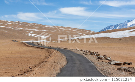 Asphalt road leading towards snow mountain, Winter road country road leading through winter mountain landscape, Road in India. 115021254