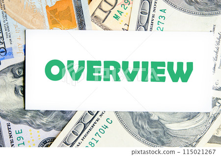 Info concept. OVERVIEW word on a white business card against a background of dollar bills Info concept. OVERVIEW word on a white business card against a background of dollar bills 115021267