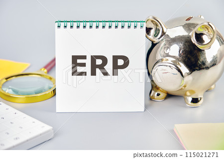Word ERP (abbreviation of Enterprise Resource Planning) written on a blank sheet in a notebook in a composition with a piggy bank, magnifying glass, calculator, stickers on a gray background Word ERP (abbreviation of Enterprise Resource Planning) written on a blank sheet in a notebook in a composition with a piggy bank, magnifying glass, calculator, stickers on a gray background 115021271